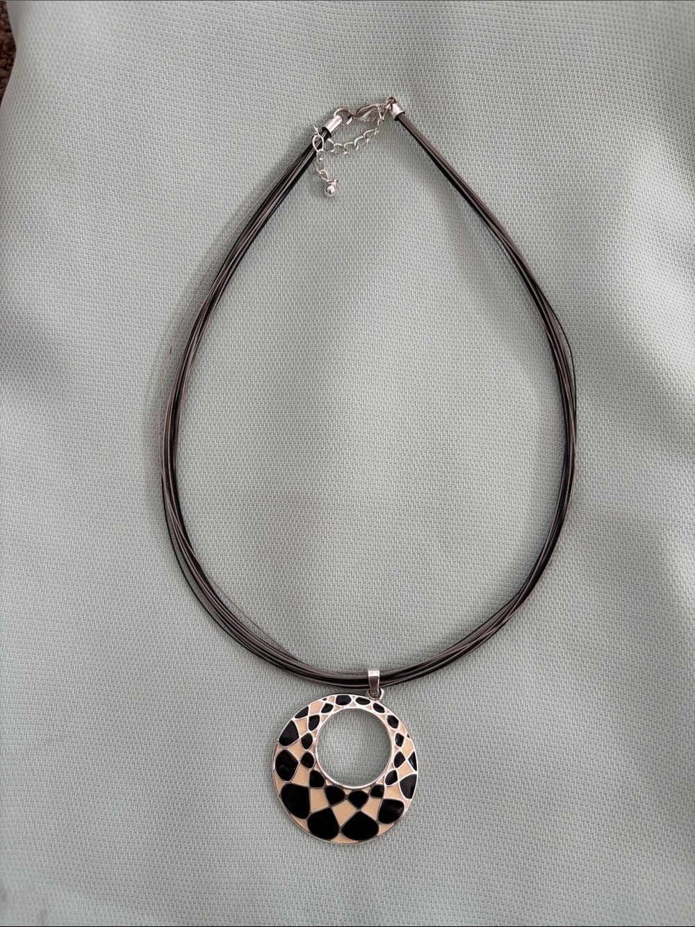 Black Multi-Strand Necklace with Round Cutout Pendant